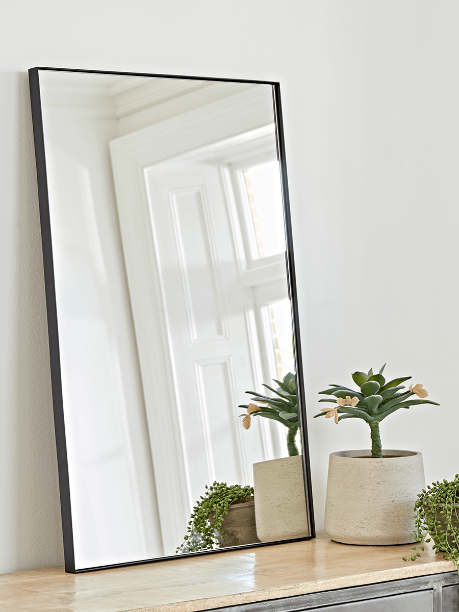 Photo of Black framed wall mirror