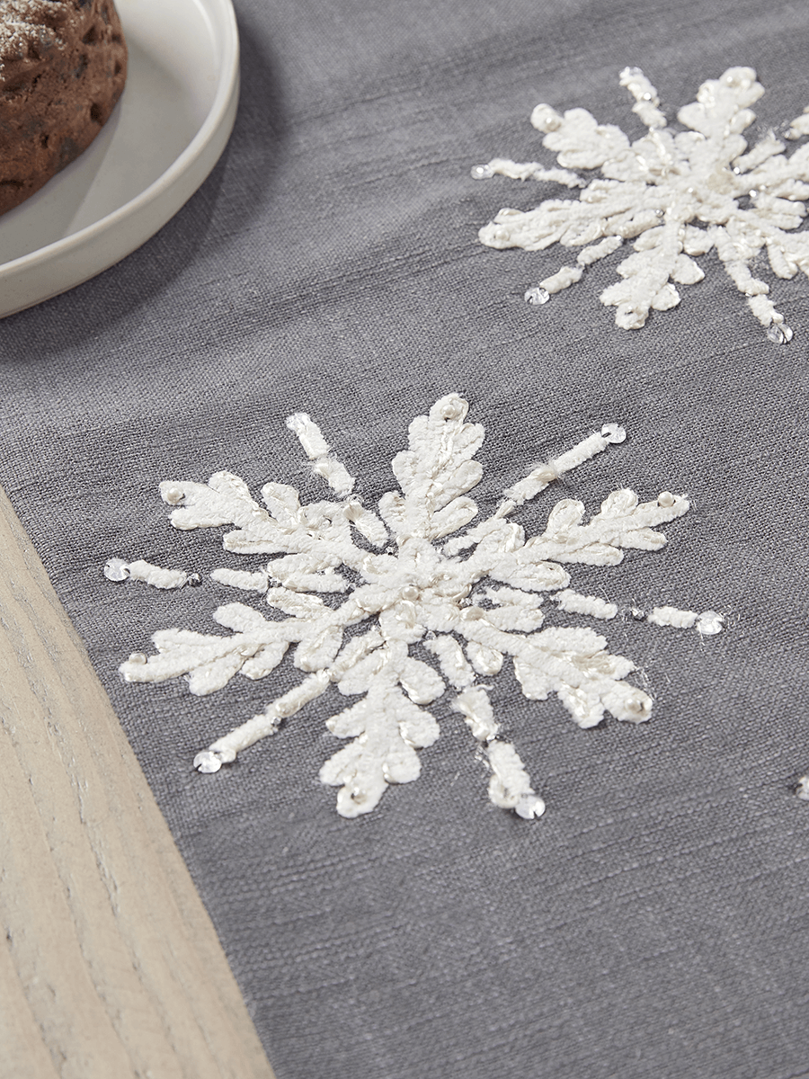 Product photograph of Embroidered Snowflake Table Runner from Cox and Cox.