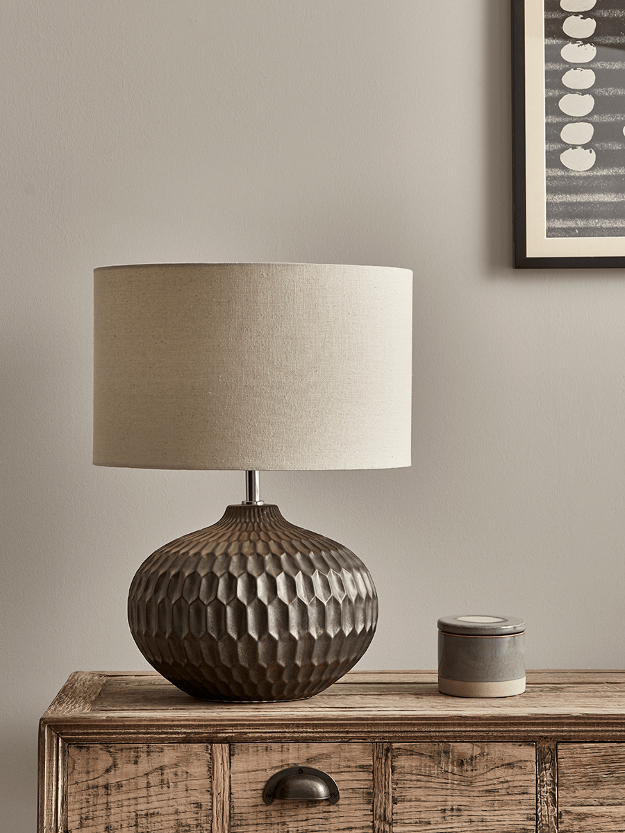 Product photograph of Bronze Geometric Textured Lamp from Cox and Cox