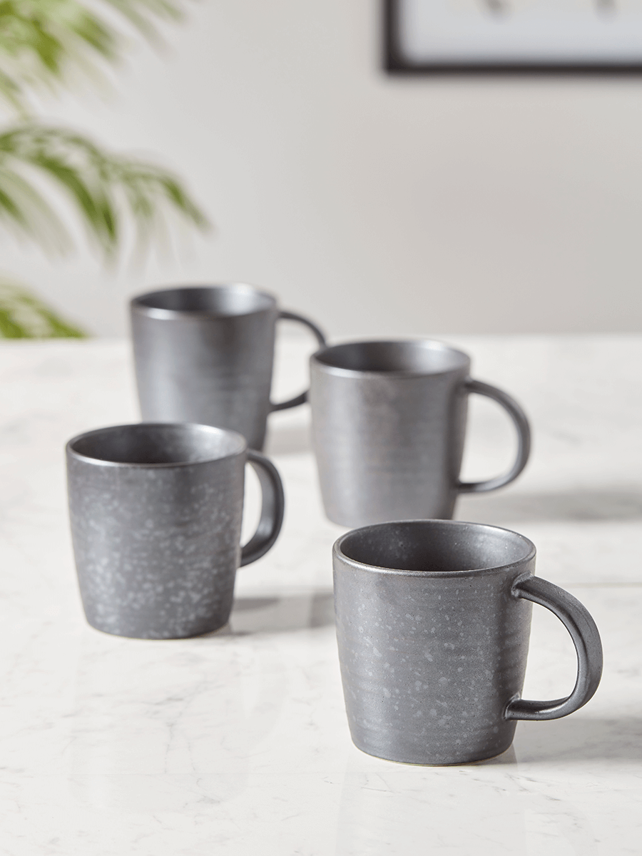 

Four Black Reactive Glazed Mugs
